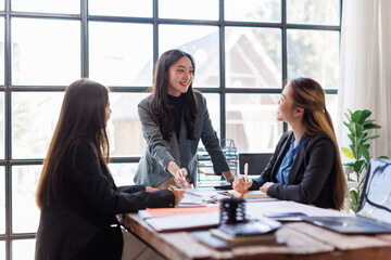 Wall Mural - Business adviser meeting to analyze and discuss the situation on the financial report in the Asian meeting room.Investment Consultant, Financial advisor and accounting concept
