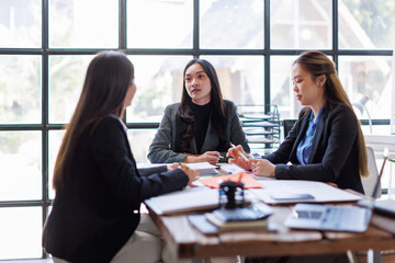 Wall Mural - Business adviser meeting to analyze and discuss the situation on the financial report in the Asian meeting room.Investment Consultant, Financial advisor and accounting concept
