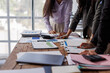 © David - Asian business women financial team work together in project brainstorm meeting. Cooperate teamwork, strategy planning, small business startup company, or office coworker concept.