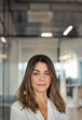 © insta_photos - Confident smiling Latin professional mid aged elegant business woman corporate leader, happy beautiful mature female executive, lady manager standing in office looking at camera, headshot portrait.