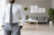 © Frank Parker - Professional man in formal attire stands confidently in an office setting with a modern design