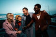 © liderina - Group of Multi-Ethnicity people having fun outdoor in the night. Celebrate.
