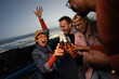 © liderina - Group of Multi-Ethnicity people having fun outdoor in the night. Celebrate.