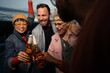 © liderina - Group of Multi-Ethnicity people having fun outdoor in the night. Celebrate.