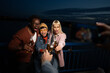 © liderina - Group of Multi-Ethnicity people having fun outdoor in the night. Celebrate.