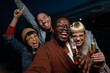 © liderina - Group of Multi-Ethnicity people having fun outdoor in the night. Celebrate.