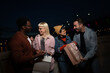 © liderina - Group of Multi-Ethnicity people having fun outdoor in the night. Celebrate.