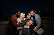 © liderina - Group of Multi-Ethnicity people having fun outdoor in the night. Celebrate.
