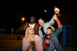 © liderina - Group of Multi-Ethnicity people having fun outdoor in the night. Celebrate.