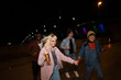 © liderina - Group of Multi-Ethnicity people having fun outdoor in the night. Celebrate.