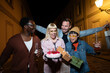 © liderina - Group of Multi-Ethnicity people having fun outdoor in the night. Celebrate.