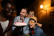 © liderina - Group of Multi-Ethnicity people having fun outdoor in the night. Celebrate.