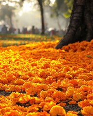Wall Mural - Vibrant marigold carpet under tree in sunlit park creating a warm and inviting autumn atmosphere