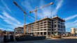 © felix_brönnimann - Construction site with cranes and unfinished building under blue sky, urban development and architecture progress in modern city environment.