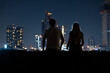 © Allison - Couple enjoys a breathtaking view of Bangkok's skyline from a rooftop at night