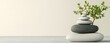© ไพลิน ไชยภักดี - a stack of zen stones with a small plant growing on top, promoting serenity and balance