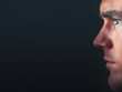 © GoodRNG - Profile portrait of a thoughtful man with intense expression and striking features against a dark background