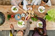© Rawpixel.com - Diverse senior friends enjoying meal together, toasting drinks. Diverse elderly toasting drinks, eating healthy meal at wooden table. Healthy dining, diverse gathering. Healthy seniors lifestyle