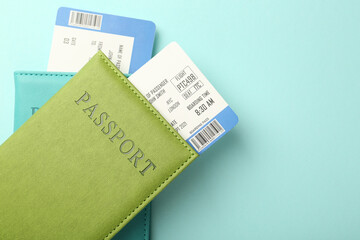 Wall Mural - Passports with tickets on light blue background, top view. Space for text