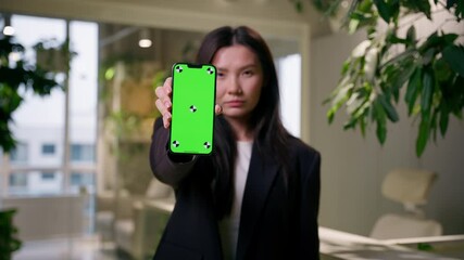 Asian sad upset dissatisfied Chinese business woman Korean girl businesswoman buyer shopper in office holding mobile phone green screen chroma key empty copy space smartphone app online shopping ads
