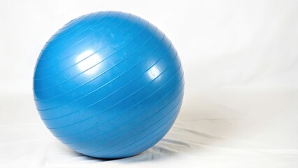 Wall Mural - Blue Exercise Ball on White Background