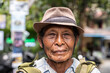 © ADDICTIVE STOCK - Elderly Balinese Man with Hat and Backpack in Outdoor Setting