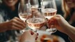 © jany sweet - Friends gather to celebrate International Day of Happiness, raising glasses filled with rosé. Laughter and joy fill the atmosphere, embodying the spirit of wellbeing and connection