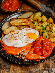 Sticker - Delicious plate featuring sunny-side-up eggs seasoned potatoes meat slices roasted pepper and savory tomato sauce.