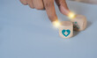© LAONG - Health insurance concept. Health care checkup and healthy trends. Access to welfare health. Wellness and medical. Wood cube and healthcare insurance icon on pastel blue background. World health day