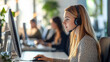 © AspctStyle - Focused female customer service representative wearing a headset working on a computer in a modern office. Call center and support service concept