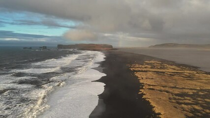 Wall Mural - Time-lapse shot of Reynisfjara Beach, Iceland , where black volcanic sand meets the Atlantic waves