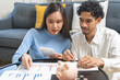 © KMPZZZ - Happy asian young couple love, wife, husband calculate income and planning, saving money to buy real estate for new home. Business finance, deposit with banking for financial planning future together.