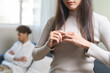 © KMPZZZ - Stressed asian young couple man, woman quarrel on couch, relationship in trouble. Wife hand holding wedding ring in disappointment and upset her husband, which may lead to divorce. Problem of family.
