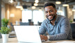 © drimerz - smiling african american man using laptop working at cafe