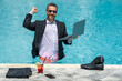 © Volodymyr - Funny corporate leader swimming. Remote job by the beach. Luxury vacation with laptop. Freelance work-life. Business humor. Handsome employee in suit in water. Relaxing after job. Success in career.