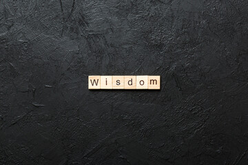 Wall Mural - wisdom word written on wood block. wisdom text on table, concept