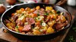 © meristock - Sizzling corned beef hash featuring golden potatoes, vibrant carrots, and green cabbage in a rustic cast iron skillet on a wooden surface.