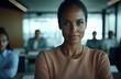 © schmidt - A confident black businesswoman is depicted in a portrait with an all African American team visible in the background