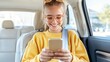 © medalinebow - Happy girl using smartphone in car, enjoying ride, wearing glasses and sweater