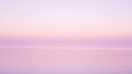 A serene landscape showcasing a tranquil pink and purple sunset over calm waters, creating a dreamy and ethereal atmosphere.