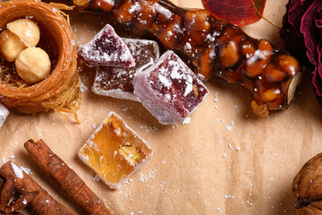 Wall Mural - Sweet food Turkish delight on wooden background, assorted locum and candy as decorated backdrop