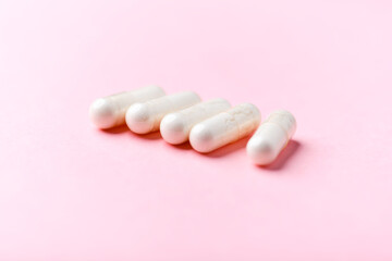 Wall Mural - Biotin capsules. Bright background. Soft focus. Close up. Copy space	