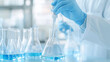 © Jirawatfoto - scientist in gloves using pipette to transfer liquid into flask in laboratory