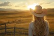 © EUT - Woman in straw hat facing sunset over field. Perfect for themes of freedom, nature, and rural life.