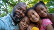 © iuricazac - In the image, a family of four with adult couple smiling at camera and two children beside them. The setting appears to be an outdoor area during daylight.