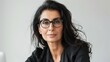 © iuricazac - A woman wearing glasses and a black blouse appears in a close-up portrait against a neutral background.