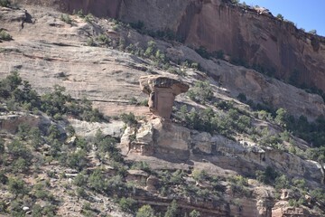 Wall Mural - Unique rock formation in a desert landscape with sparse vegetation. Colorado National Monument, USA