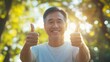 © Chayanin Wongpracha - happy mature man giving thumbs up outdoors