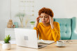 © Юлия Завалишина - African woman touching temples experiencing stress. Girl at home office tired of working feeling headache sick rubbing temples forehead. Long laptop usage computer vision syndrome. Office syndrome
