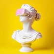 © Elena - Statue of a woman wearing virtual reality goggles. The sculpture is a bust on a yellow background. VR headset. Concept of future technology. Combination of history and modernity. Surrealism, 3 D model